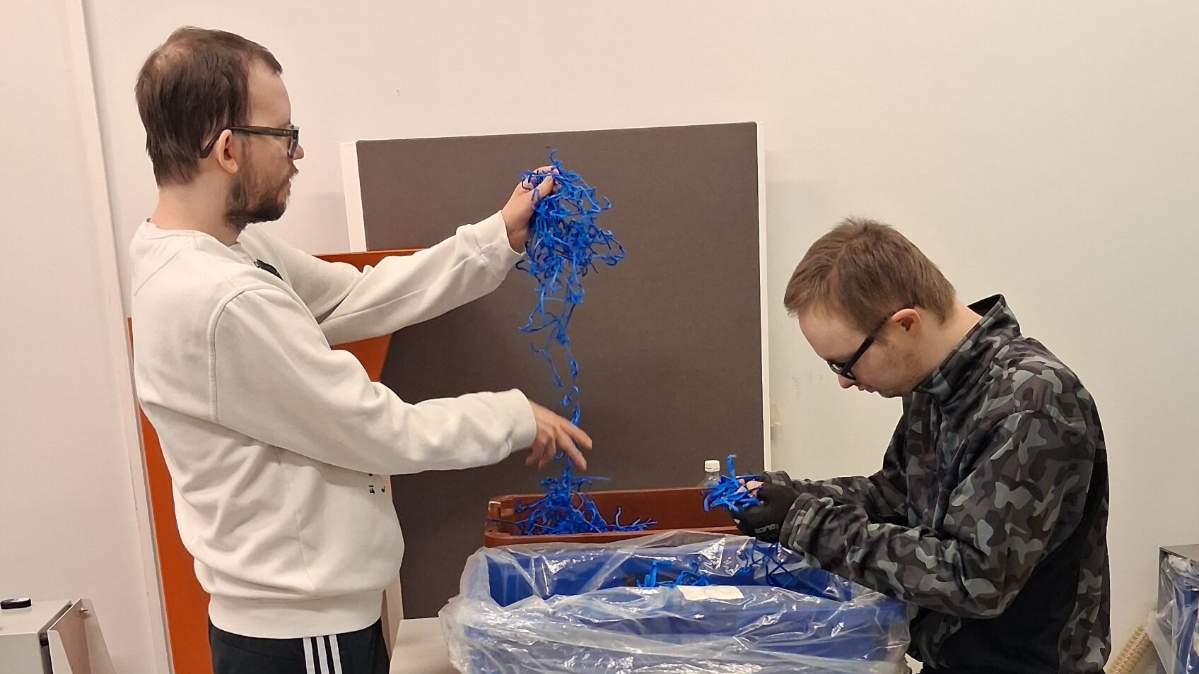 Roni Leivo and Iiro Blom separating materials.