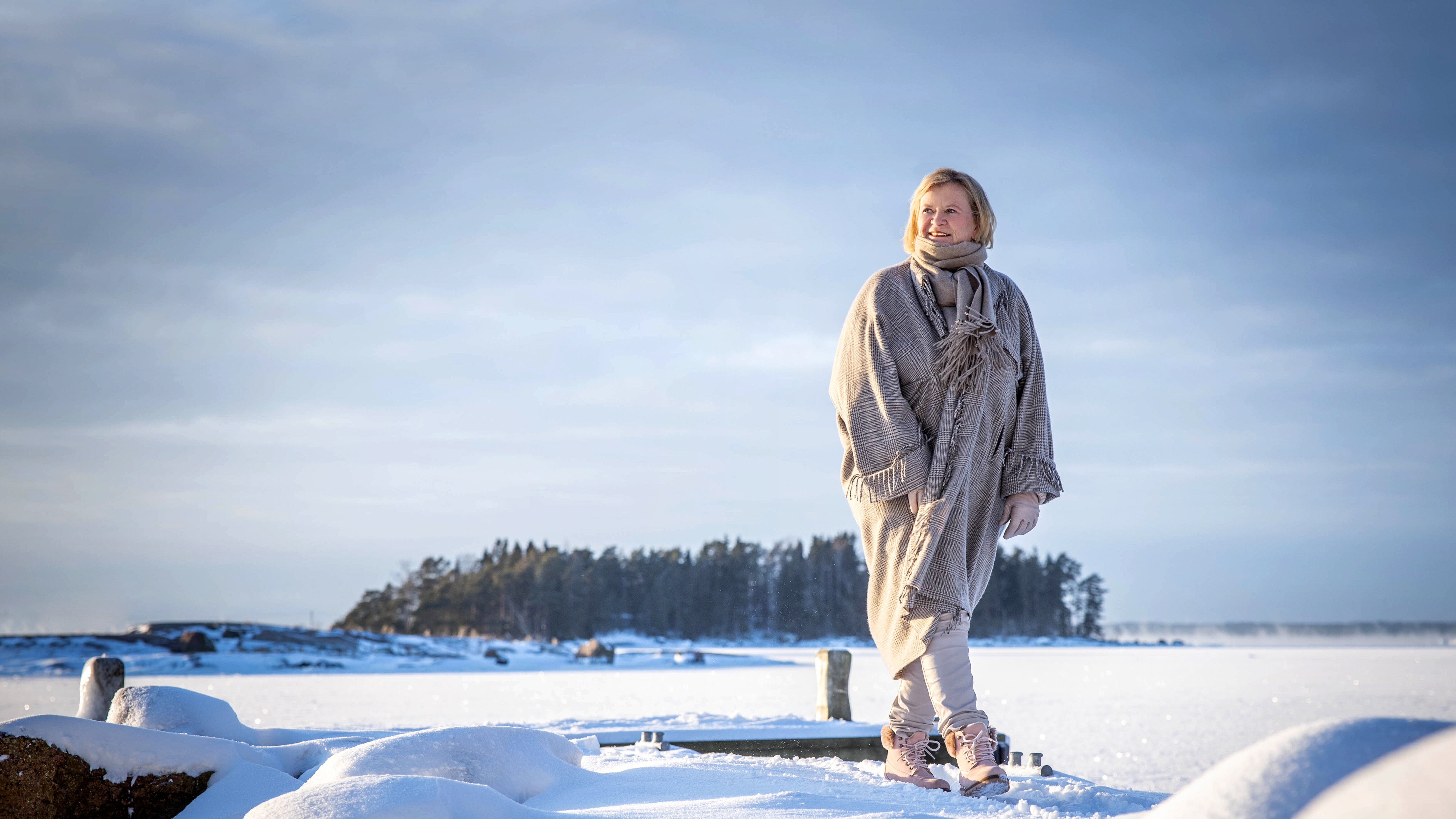 Marjo Miettinen, one of Ensto’s owners and Chairman of the Board, standing in a wintery landscape.