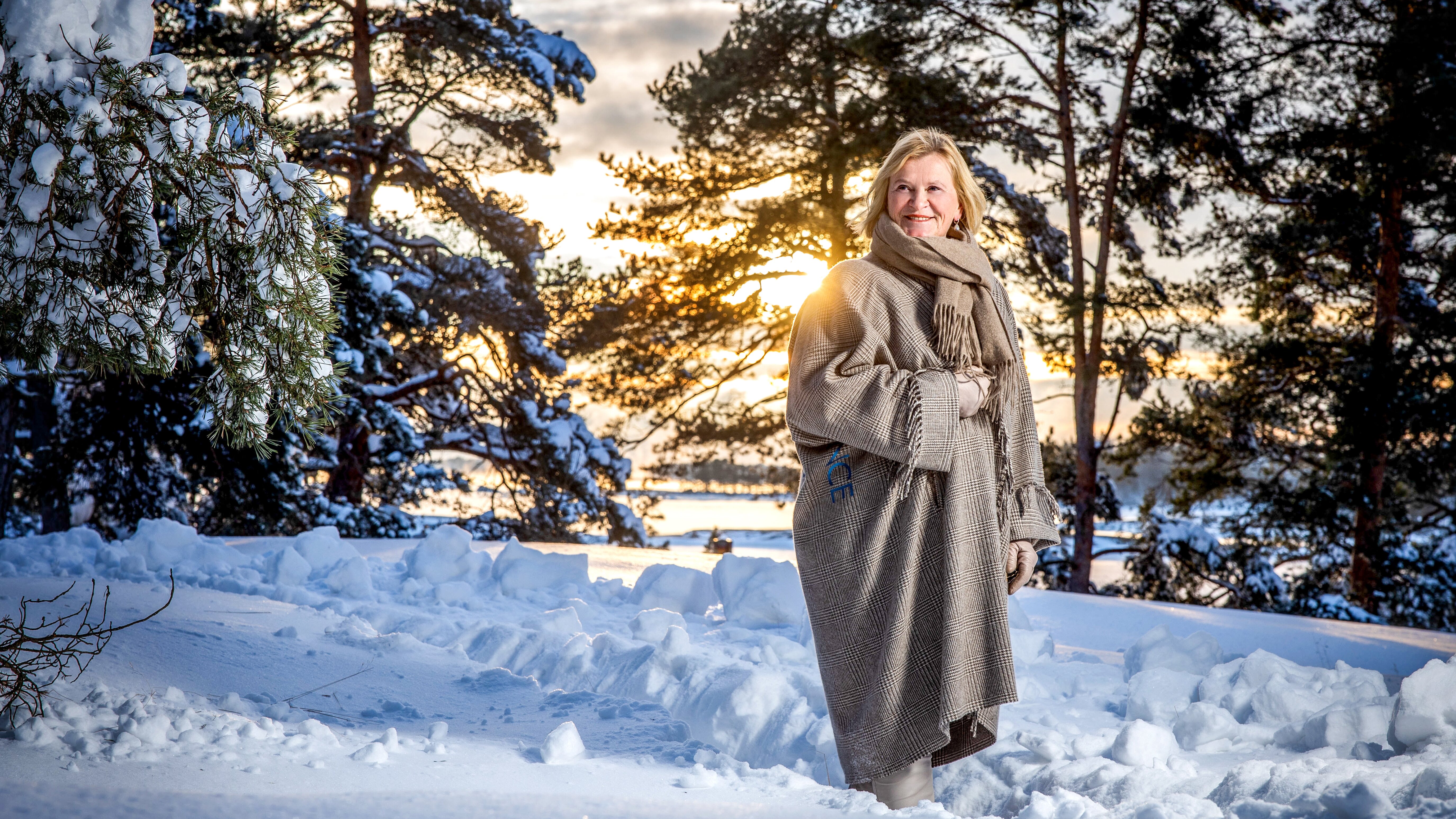 Marjo Miettinen, one of Ensto’s owners and Chairman of the Board, standing in a wintery landscape.